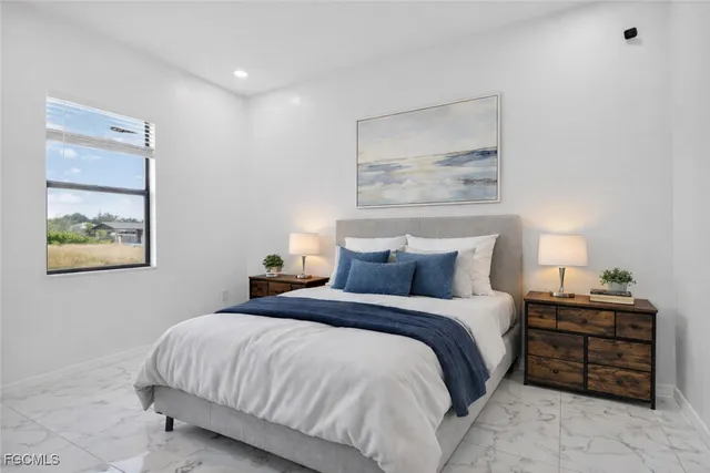 a bedroom with a bed and a painting on the wall