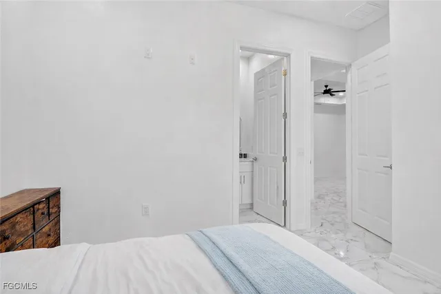 a bedroom with a bed and a bathroom