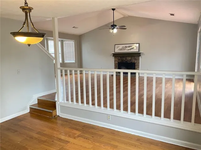 a view of a room with wooden floor