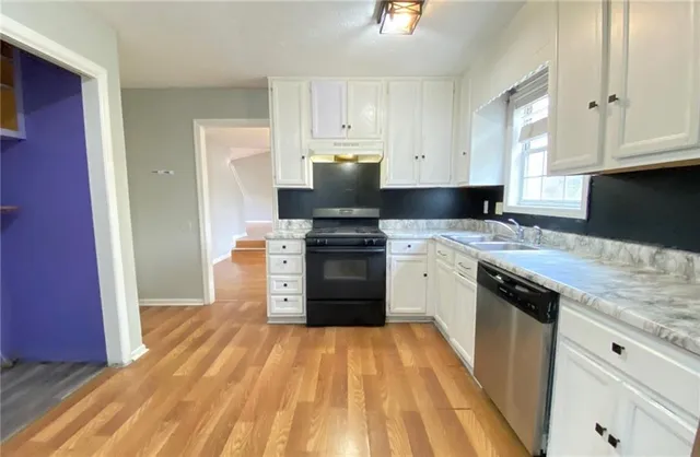 a kitchen with granite countertop a stove and a sink