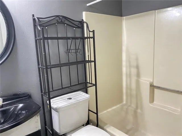 a bathroom with a toilet and a shower