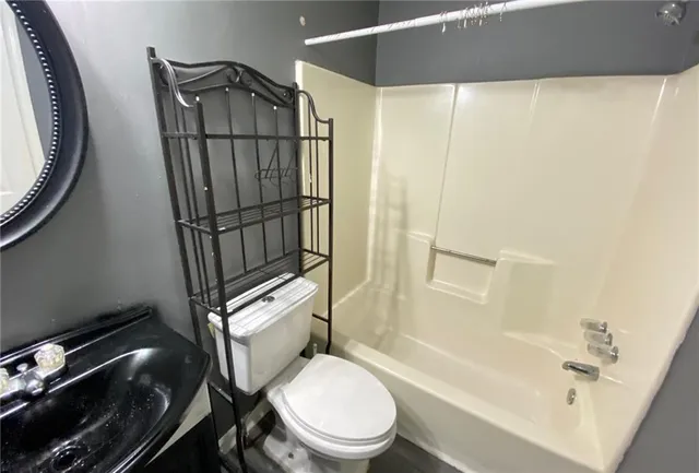 a bathroom with a toilet and a shower