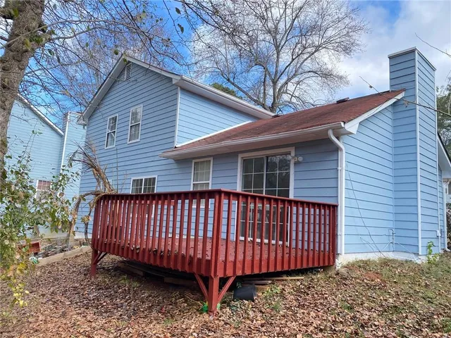 a view of a house with a wooden deck