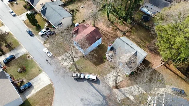 an aerial view of a house with a yard