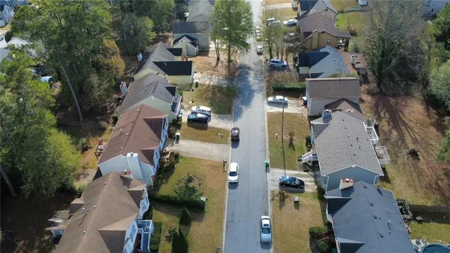 an aerial view of residential houses with outdoor space