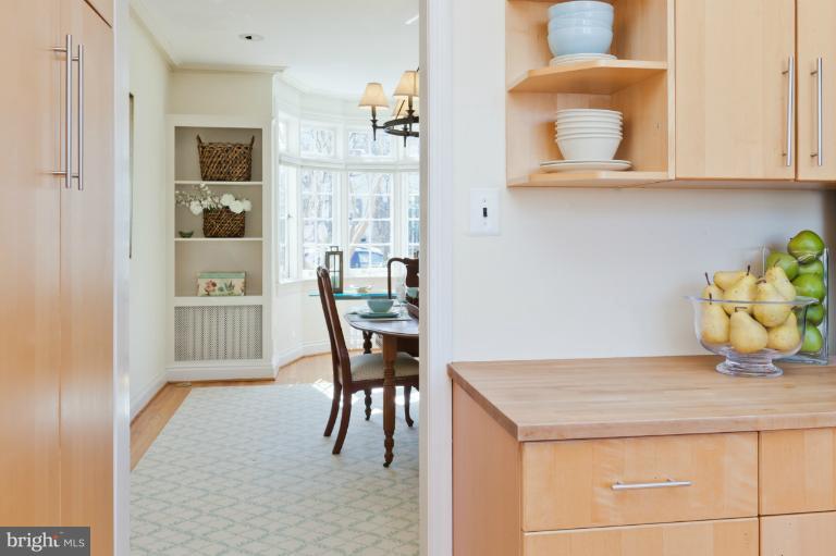 3219 Klingle Road Northwest Washington, DC 20008 - Photo 11 of 30 a kitchen with a dining table chairs and cabinets