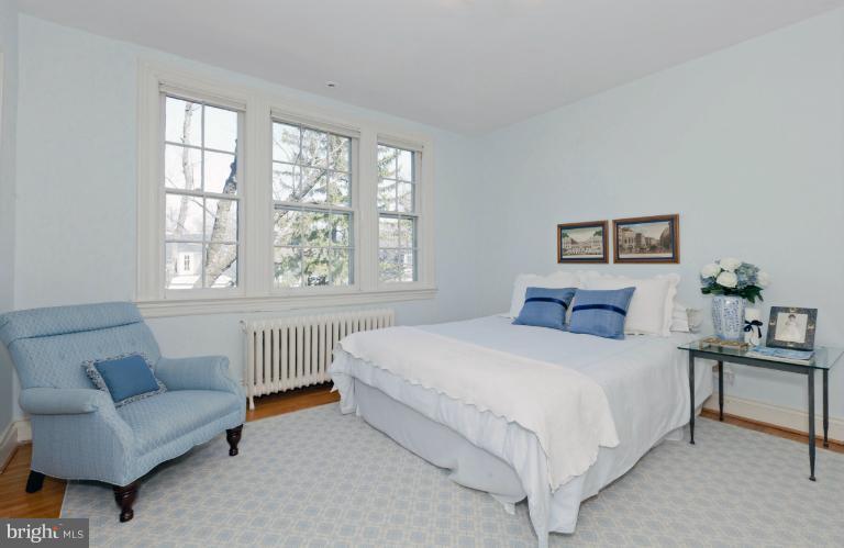 3219 Klingle Road Northwest Washington, DC 20008 - Photo 6 of 30 a bedroom with a bed a couch and a couch with outer view