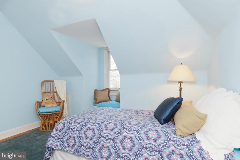 3219 Klingle Road Northwest Washington, DC 20008 - Photo 8 of 30 a bedroom with bed and a table