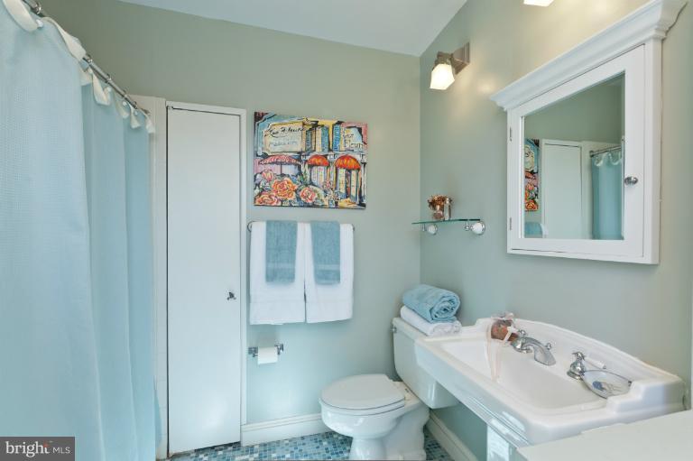 3219 Klingle Road Northwest Washington, DC 20008 - Photo 9 of 30 a bathroom with a sink mirror and toilet