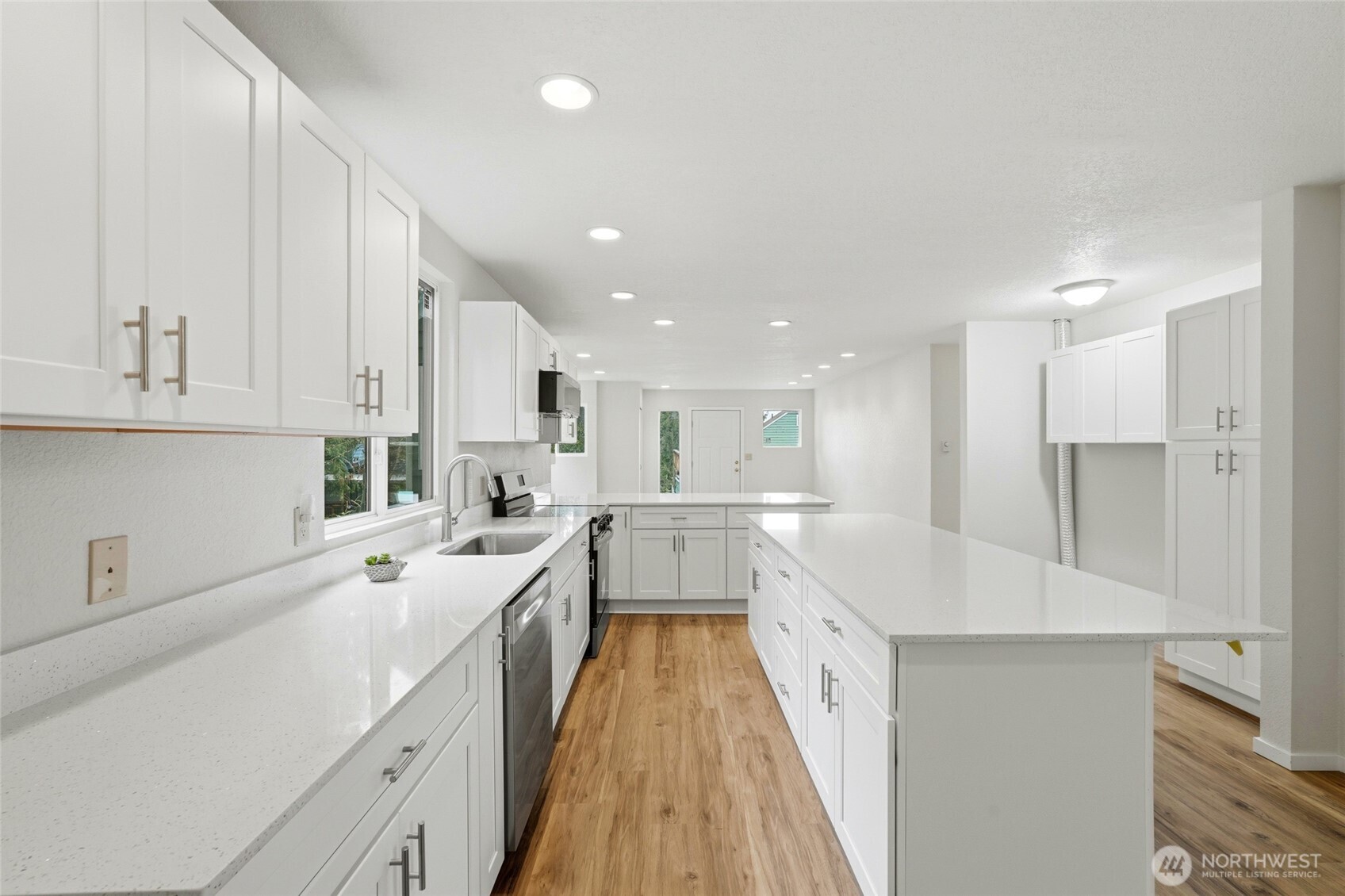 4404 Terrace Drive, Unit 8 Everett, WA 98203 - Photo 12 of 23 a large white kitchen with a white stove top oven and white cabinets