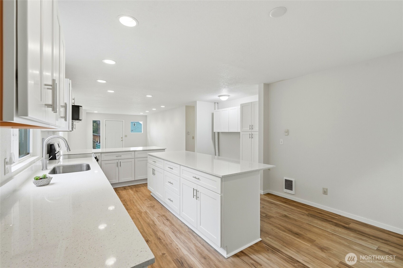 4404 Terrace Drive, Unit 8 Everett, WA 98203 - Photo 13 of 23 a large white kitchen with wooden floors and white walls