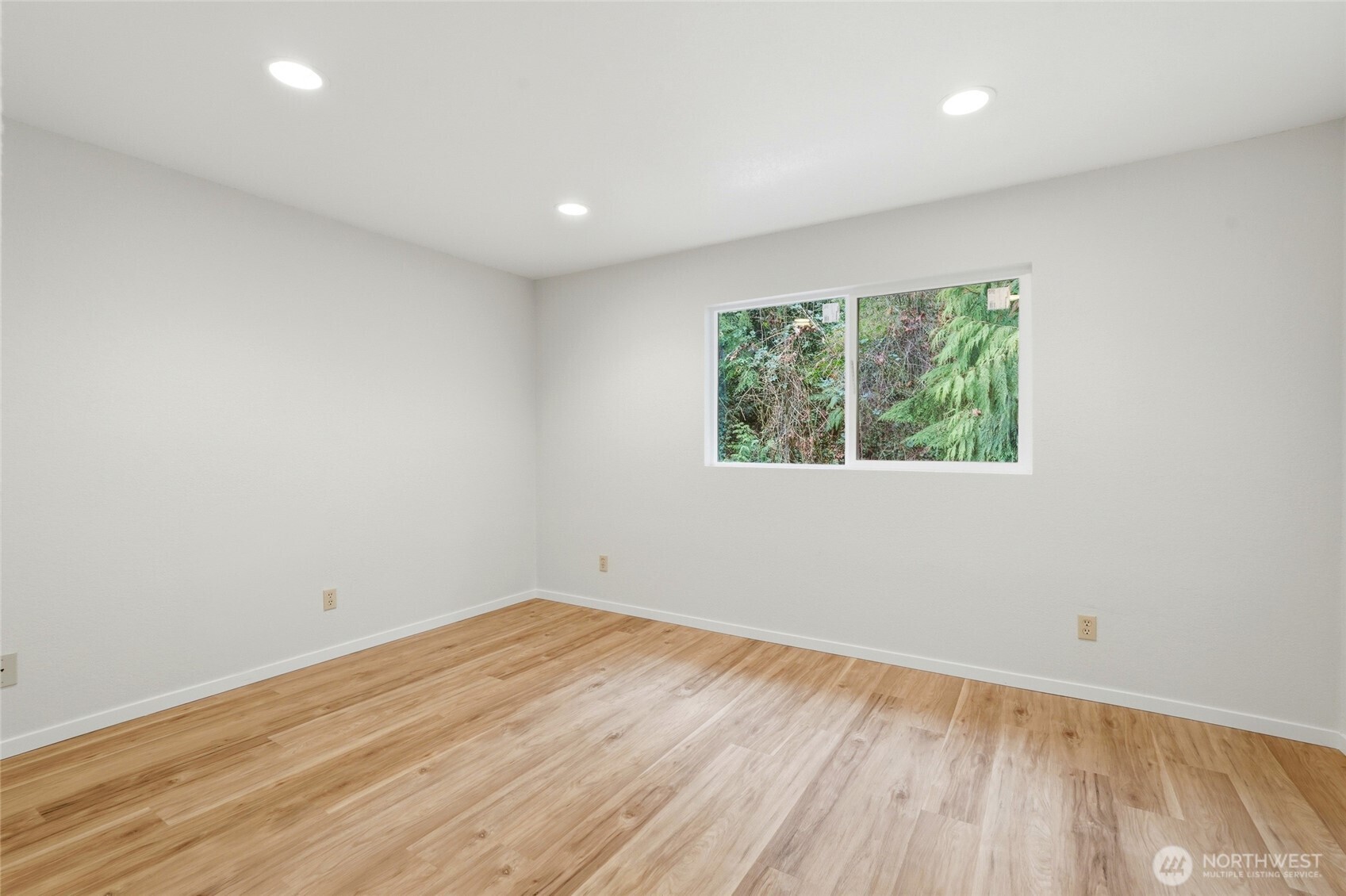 4404 Terrace Drive, Unit 8 Everett, WA 98203 - Photo 17 of 23 an empty room with wooden floor and windows