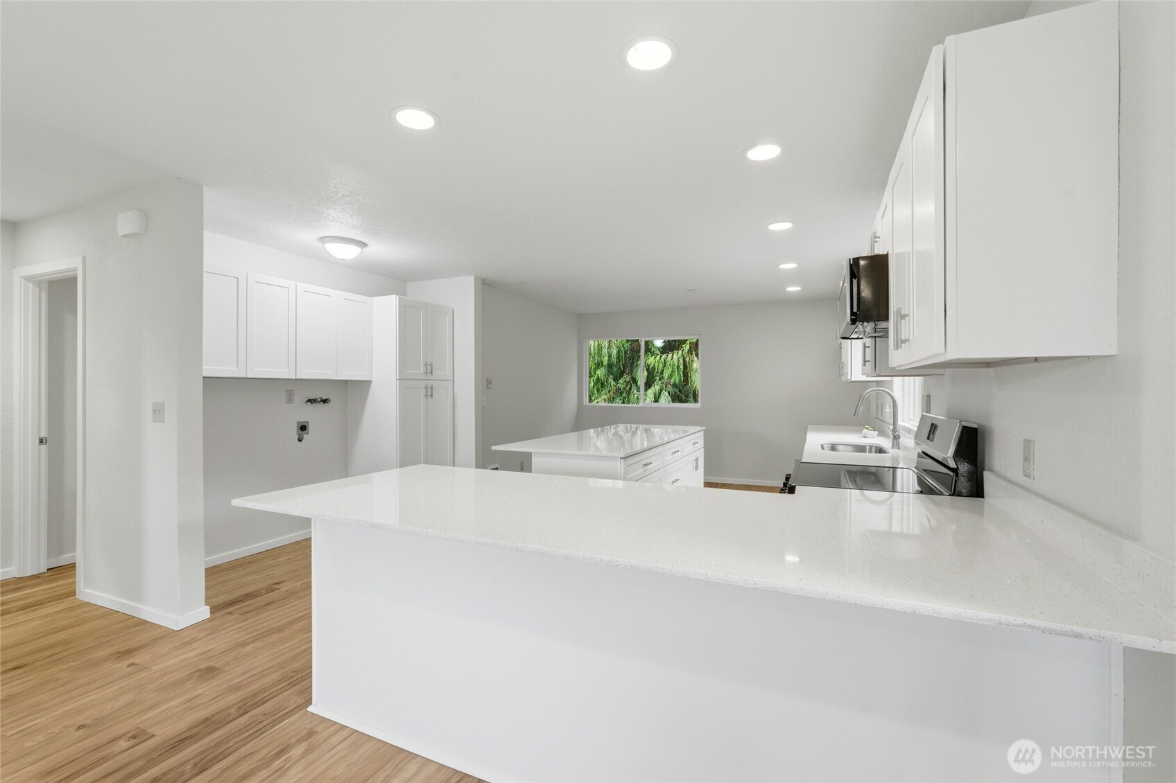 4404 Terrace Drive, Unit 8 Everett, WA 98203 - Photo 7 of 23 a large white kitchen with stainless steel appliances
