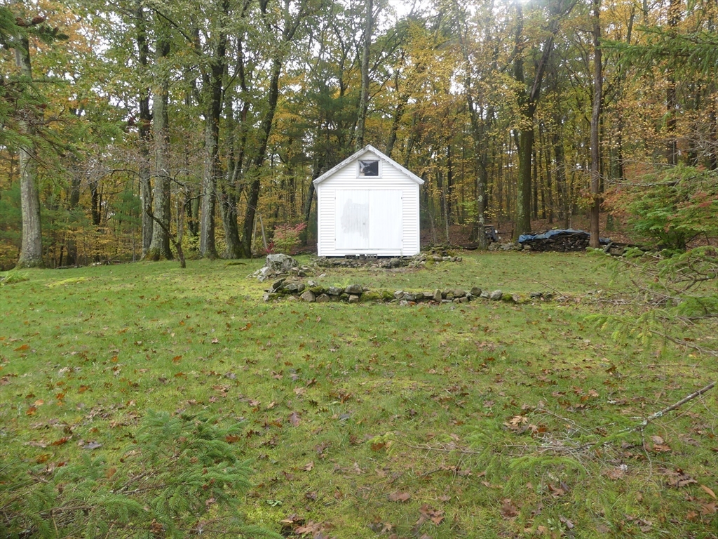 151 Fowler Road Northbridge, MA 01534 - Photo 21 of 29 a backyard of a house with a garden and trees