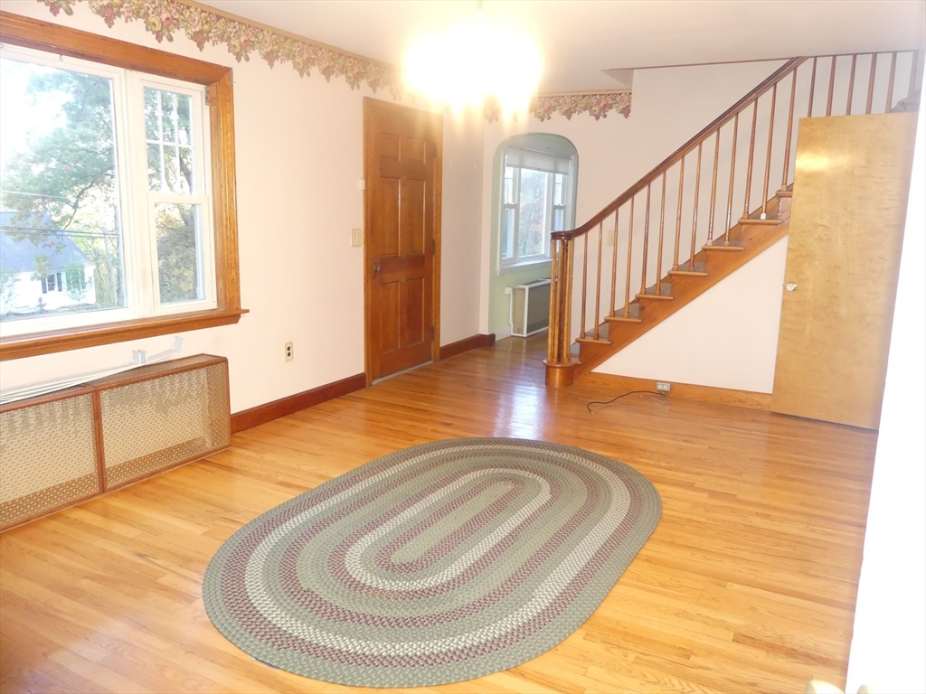 151 Fowler Road Northbridge, MA 01534 - Photo 6 of 29 a view of a livingroom with wooden floor and staircase