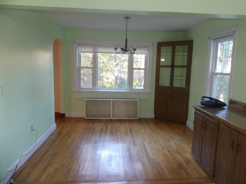 151 Fowler Road Northbridge, MA 01534 - Photo 7 of 29 an empty room with wooden floor and windows