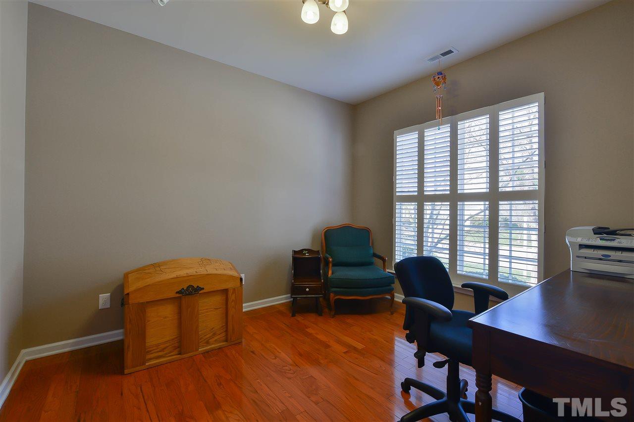 3412 Secretariat Way Raleigh, NC 27614 - Photo 3 of 25 a workspace with furniture and a window