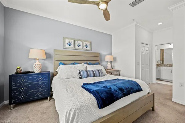 a bedroom with a bed and painting on the wall