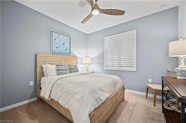 a bedroom with a bed and a desk