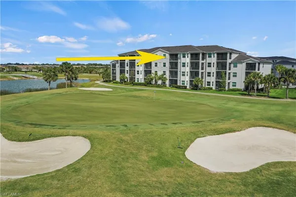 a view of a big building with a big yard and large trees