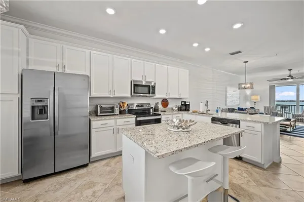 a kitchen with a sink a counter top stainless steel appliances and cabinets