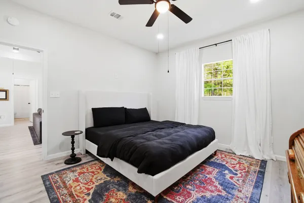 a bedroom with a bed and window