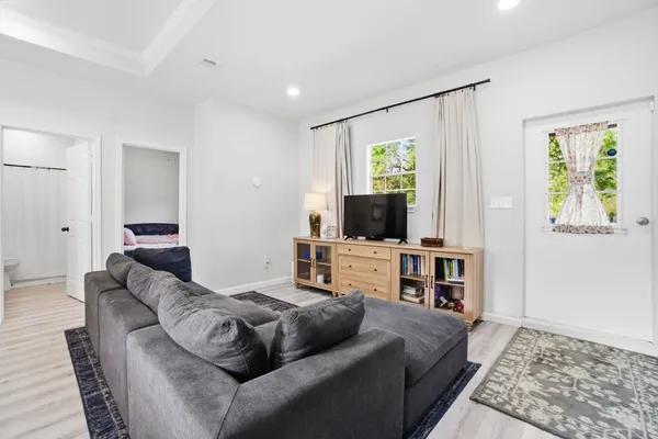 a living room with furniture and a flat screen tv