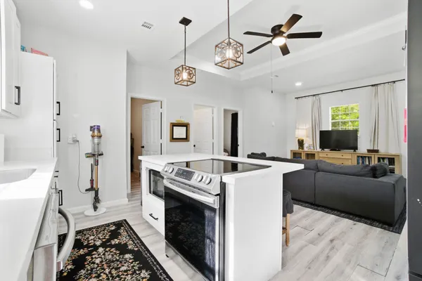 a kitchen with a stove and a chandelier