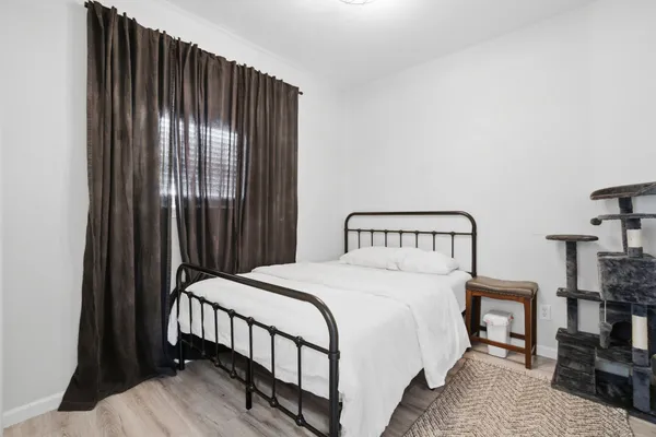 a bedroom with a bed and a night stand