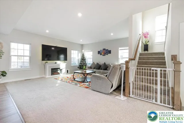 a bedroom with bed mirror and window