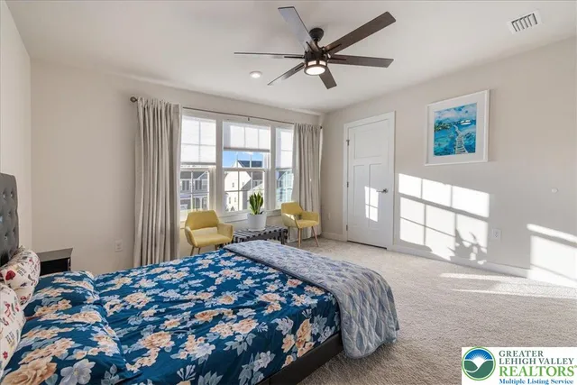 a bedroom with a bed and a view of bedroom