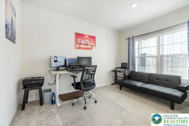 a view of a livingroom with workspace and a couch