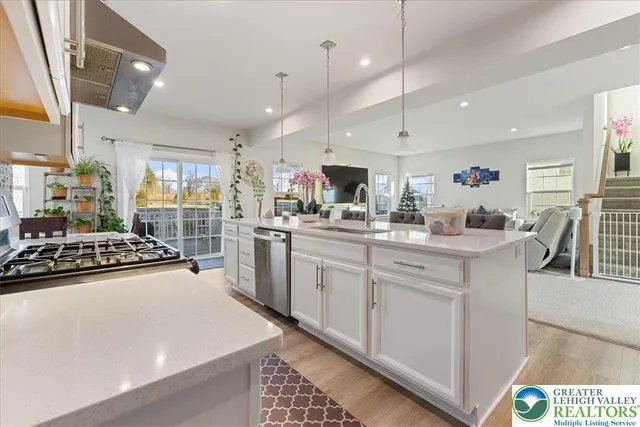 a kitchen with stainless steel appliances a refrigerator stove and sink