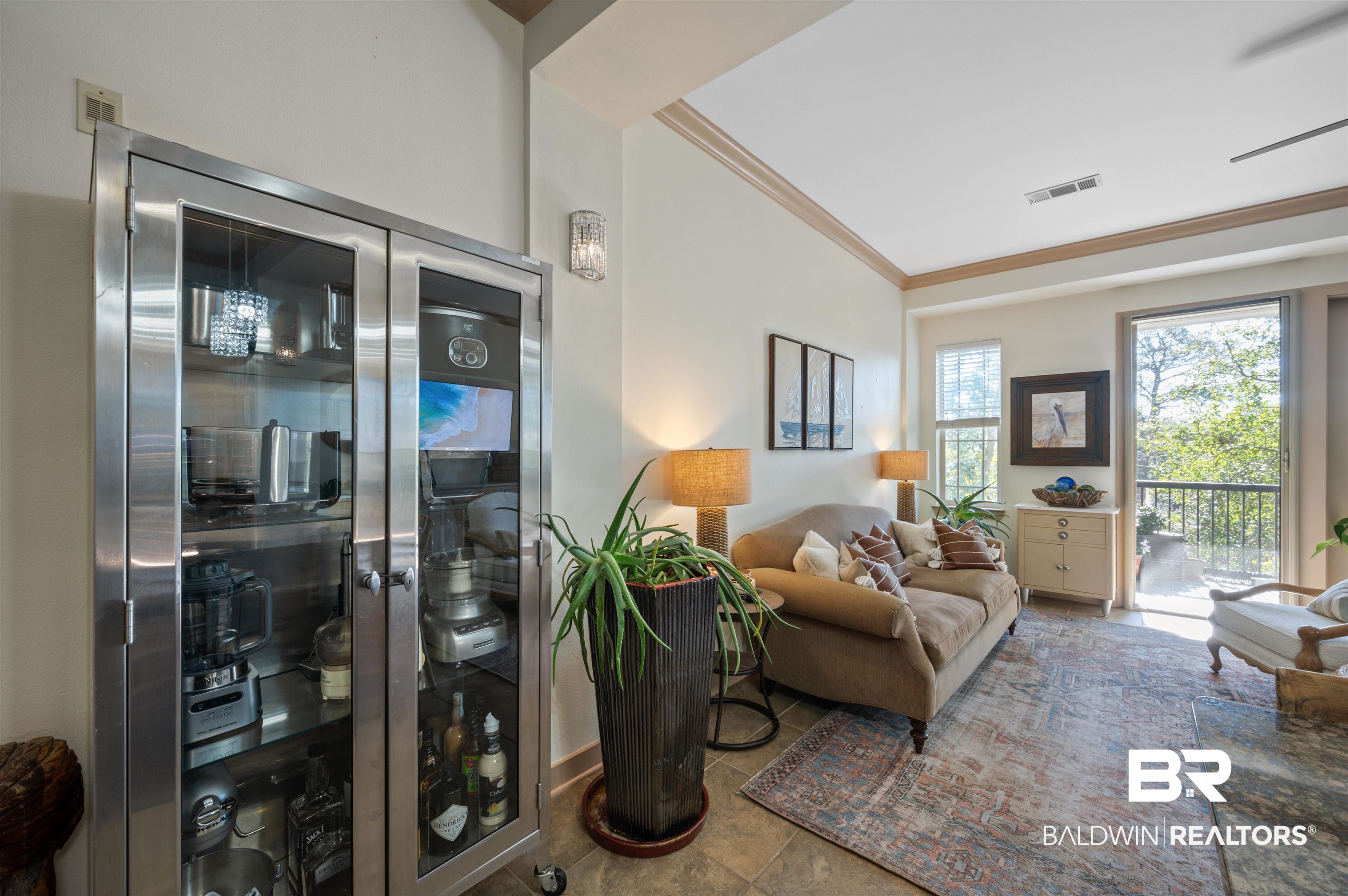 1430 Regency Road, Unit B202 Gulf Shores, AL 36542 - Photo 22 of 33 Living room featuring visible vents and crown molding