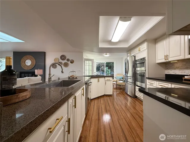 a kitchen with sink stove and cabinets