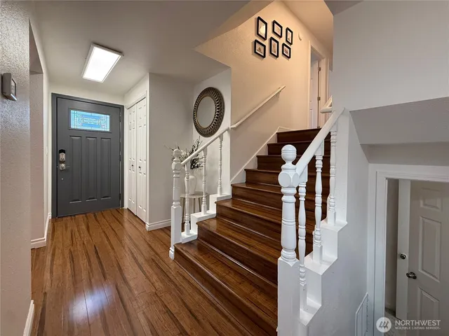 a view of entryway and hall with wooden floor