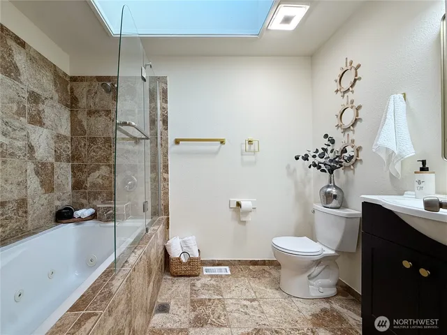 a bath room with a toilet and a bath tub