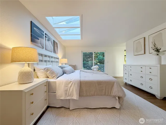 a bedroom with two beds and painting on the wall