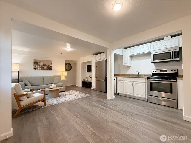 a kitchen with a sink and steel appliances