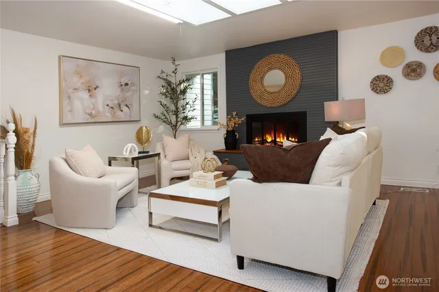 a living room with furniture a fireplace and wall paintings