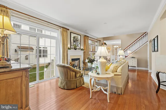 a dining room with furniture a chandelier and wooden floor