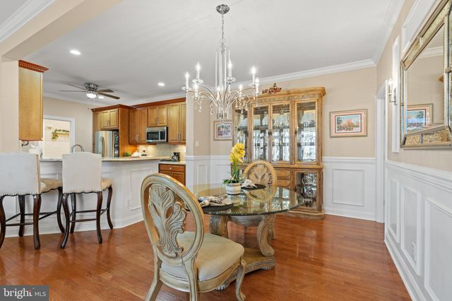 a view of a dining room with furniture wooden floor and chandelier