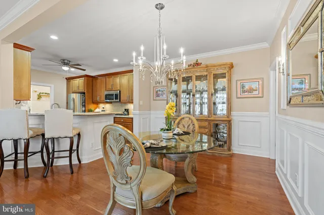 a view of a dining room with furniture wooden floor and chandelier