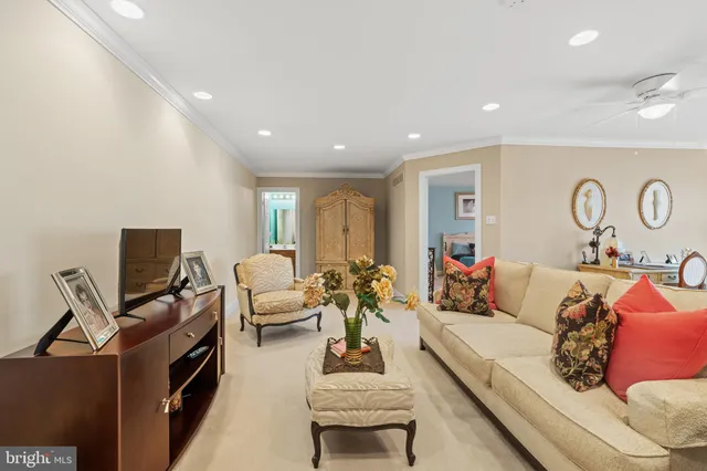 a living room with a table chairs and a chandelier