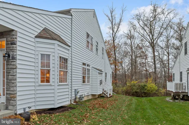 a view of a hallway with furniture and wooden floor