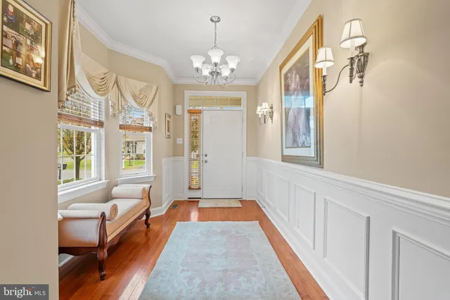 a view of entryway and hall with wooden floor
