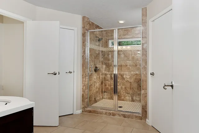 a bathroom with a shower and a sink