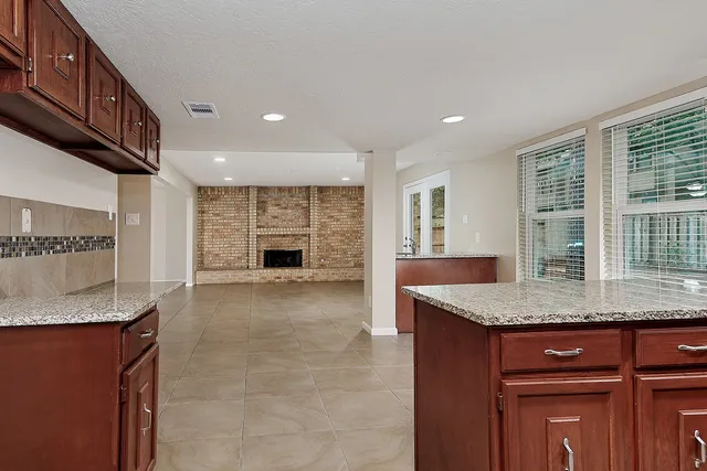 a kitchen with granite countertop a sink and a counter top space