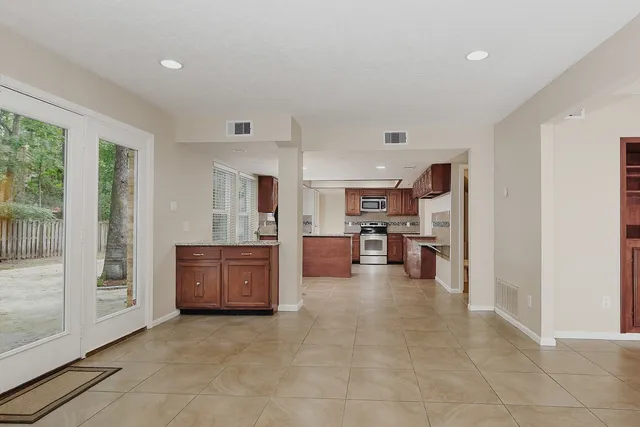 a large space with a large window and furniture