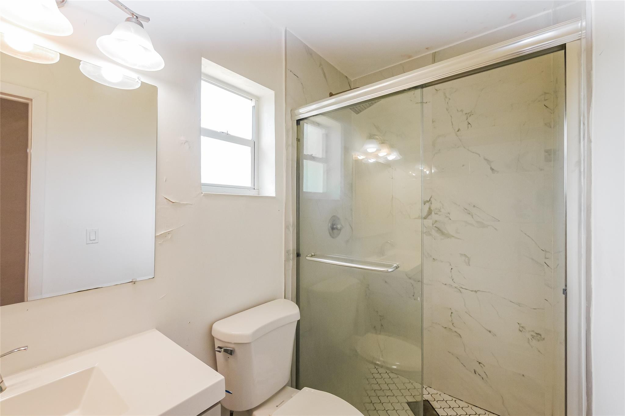 730 Northwest 18th Street Pompano Beach, FL 33060 - Photo 6 of 15 a bathroom with a shower a toilet and a sink